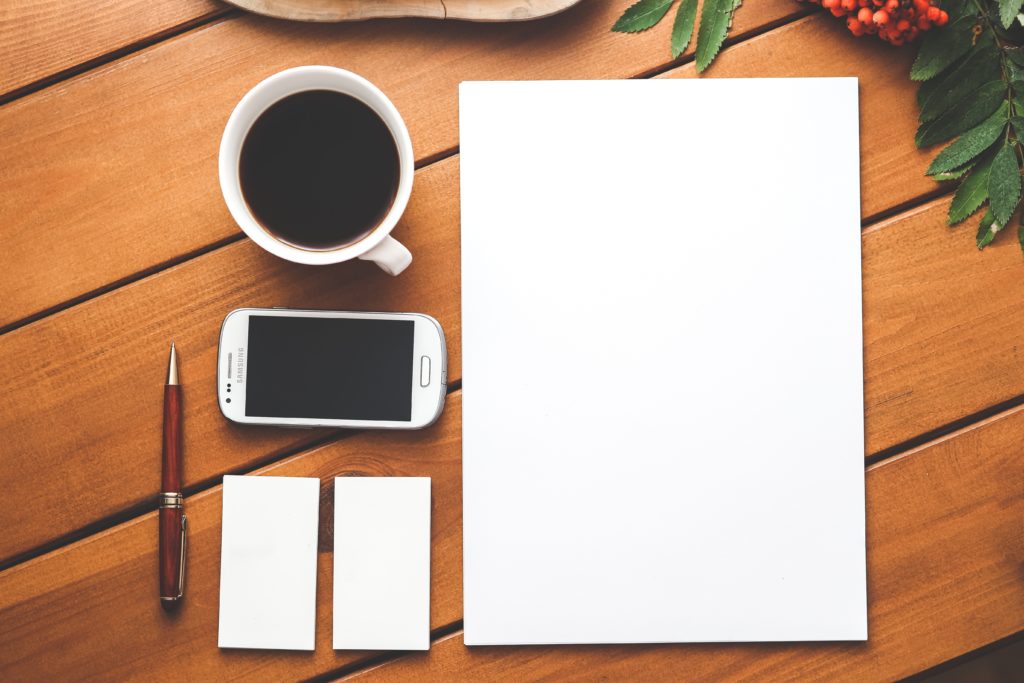 Cup of coffee, blank paper, phone and pen | Purple Horizons