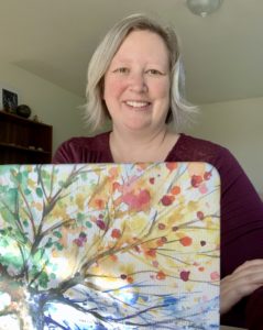Tyana Kelley behind a laptop | Purple Horizons Coaching